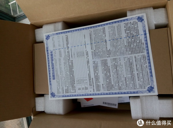 确认包装完好无损，正式开箱。首先看到的是最上面的保修卡。