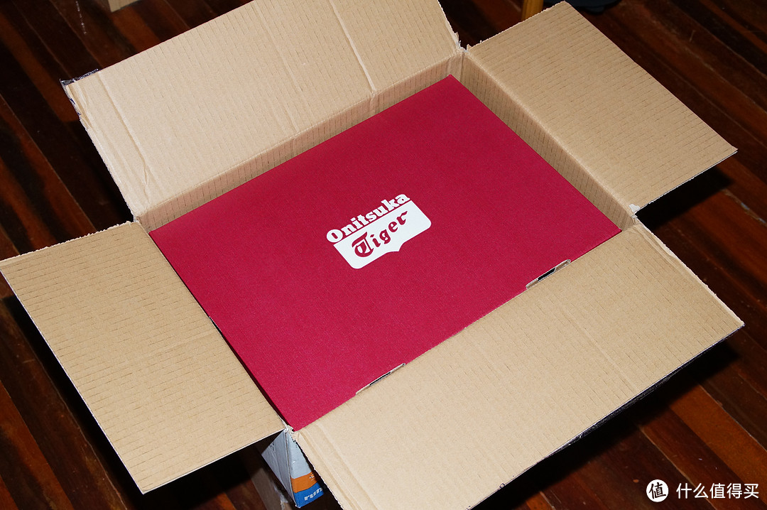 打开外包装箱子，里面是鞋盒。大红底色配白色鬼冢虎LOGO。
