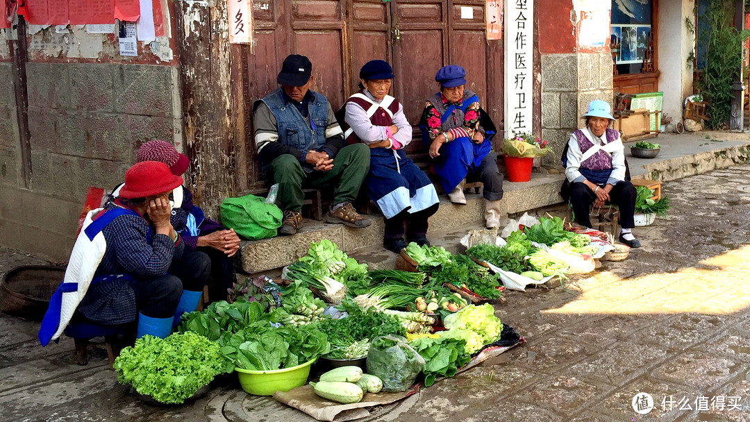 白沙古镇，老人们围坐在镇门口，晒太阳，唠嗑兼卖菜。