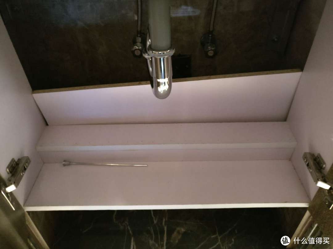 公用卫生间洗手盆柜内隔板未安装，且有其他五金件