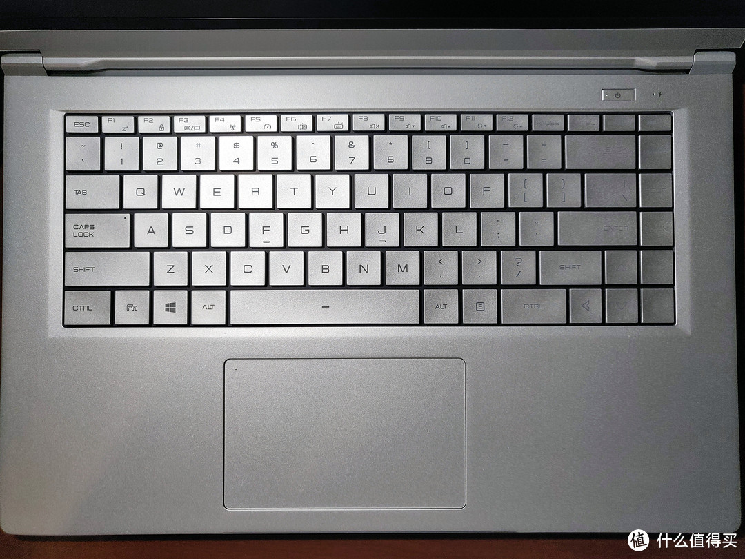 ▲ 银色C面加银色键盘，直角键帽。按键间距挺大的，打字手感还行。下方触摸板很大，不过手感一般。