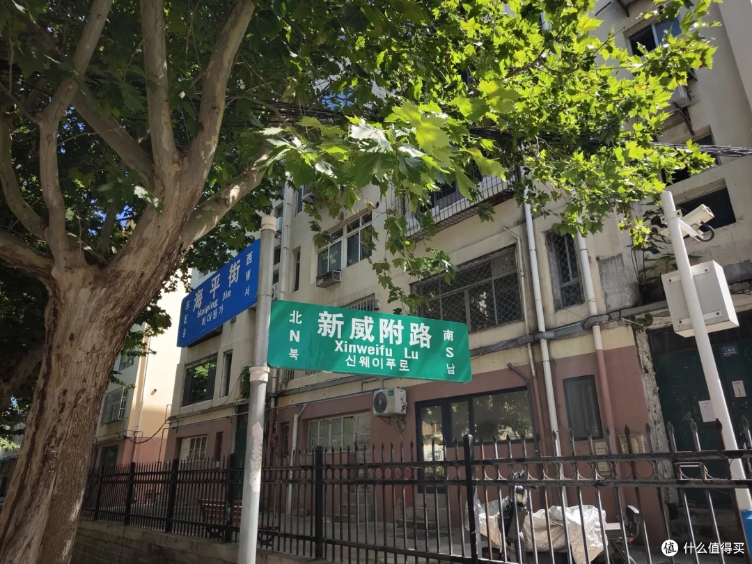 新威附路与海平街路口的路牌，中文路名下方标注着韩文